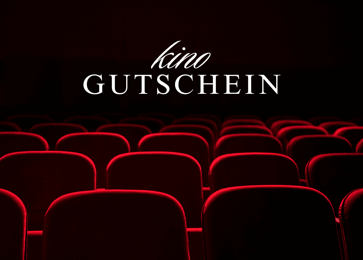 Empty red cinema seats in a dark theater with 'kino GUTSCHEIN' text at the top.