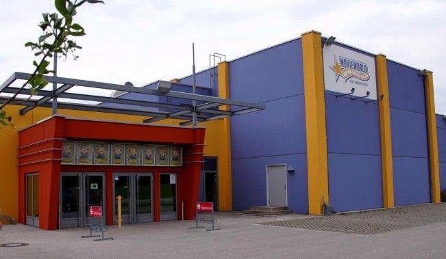 Colorful Mega Movies building exterior with purple, yellow, and red sections.